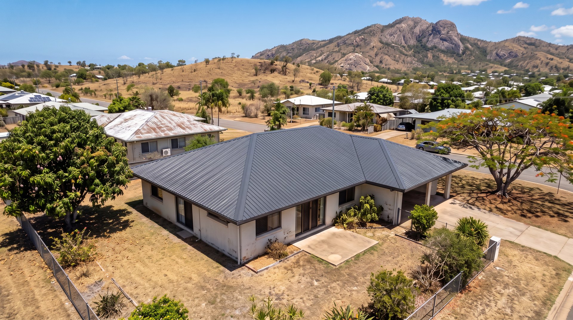 After: Townsville home with its Colorbond roof re-coated in charcoal, Castle Hill in the background
