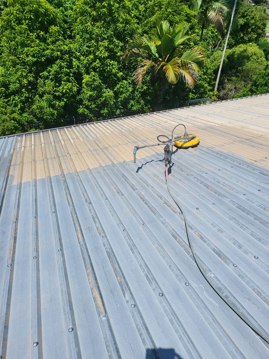 High-pressure cleaning a metal roof before painting